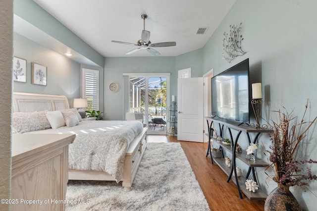 bedroom with hardwood / wood-style flooring, access to exterior, and ceiling fan