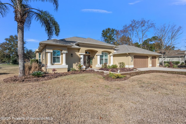 view of front of home with a garage and a front lawn