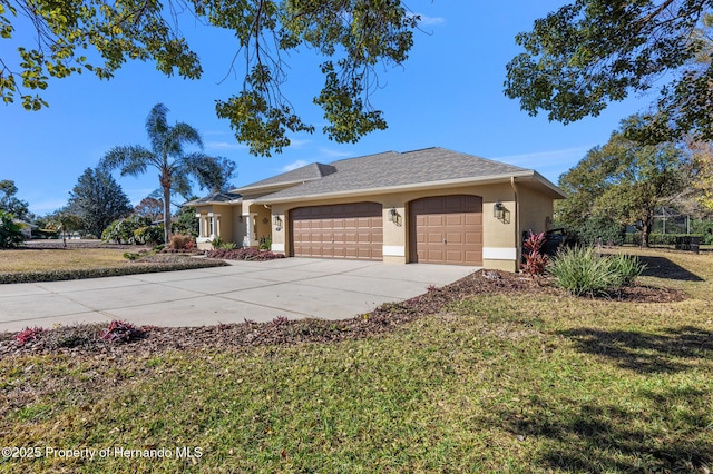 view of front of property with a garage and a front yard