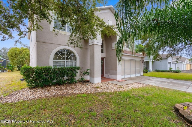 view of front of house with a garage and a front lawn