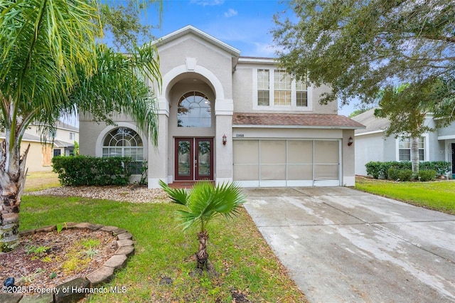 view of front of house with a garage and a front yard