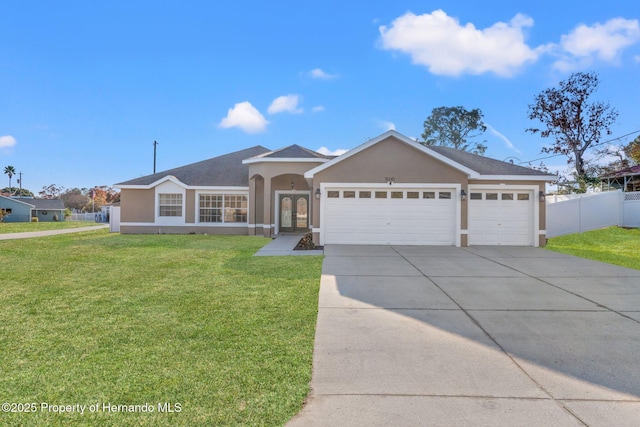 single story home featuring a garage and a front lawn