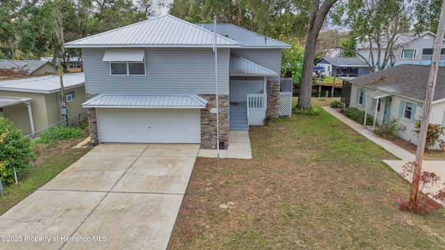 view of front of property with a garage and a front yard