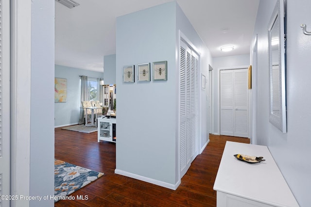 hall with dark wood-type flooring