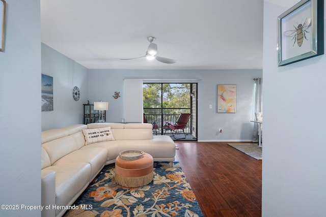 living room with dark wood-type flooring and ceiling fan