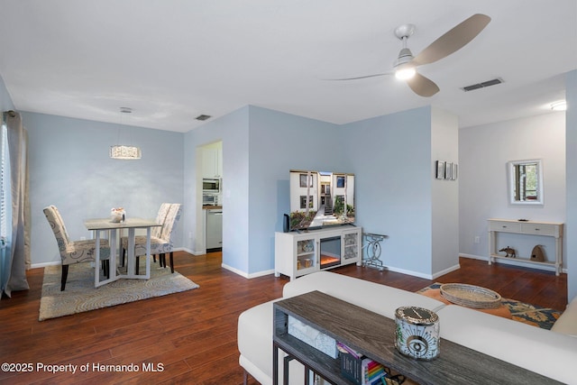 dining area featuring dark wood-type flooring and ceiling fan