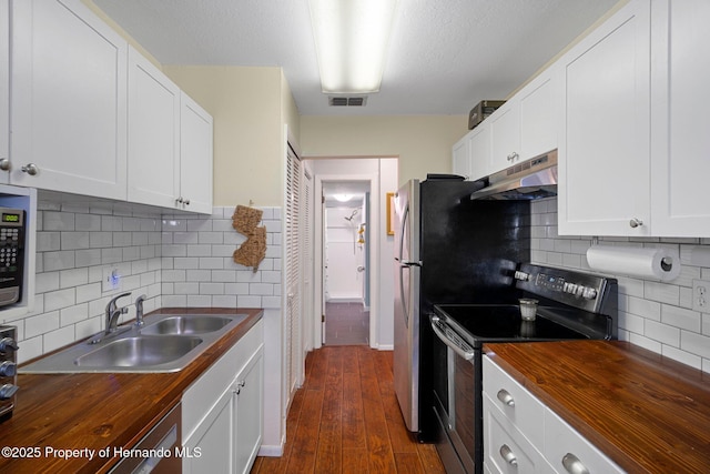 kitchen with tasteful backsplash, stainless steel electric range oven, white cabinetry, and wood counters