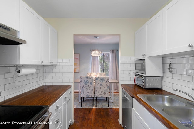 kitchen featuring white cabinetry, sink, and butcher block countertops