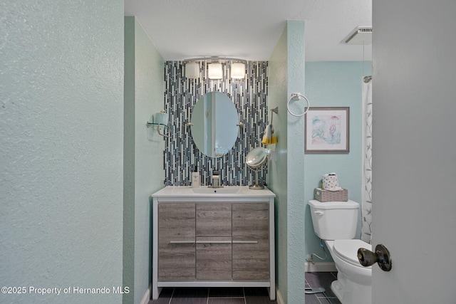 bathroom featuring tile patterned floors, vanity, and toilet