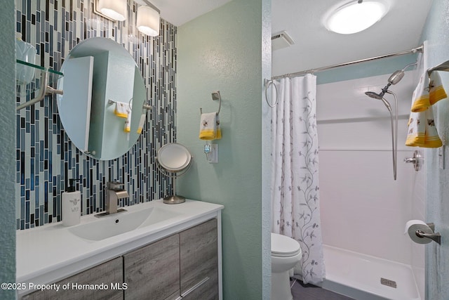 bathroom featuring vanity, toilet, a shower with shower curtain, and decorative backsplash