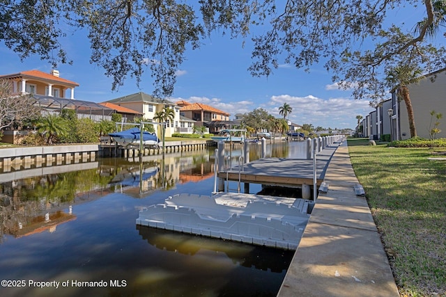 dock area featuring a lawn and a water view