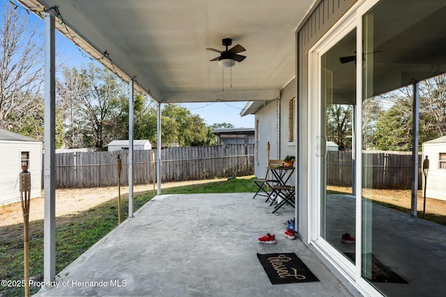 view of patio / terrace featuring a storage shed and ceiling fan