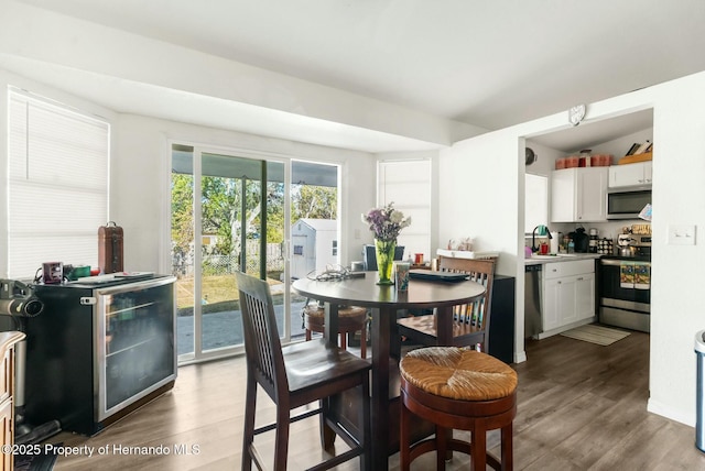 dining room featuring sink and dark hardwood / wood-style floors