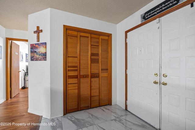 foyer featuring a textured ceiling