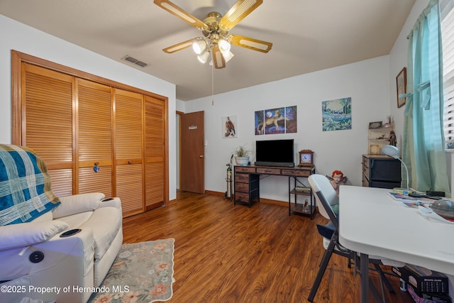 office with dark hardwood / wood-style floors and ceiling fan