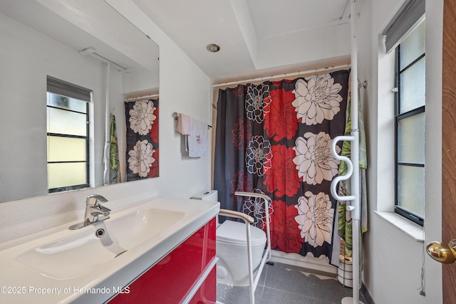 bathroom featuring vanity and toilet