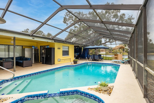 view of swimming pool with an outdoor hangout area, a patio, and glass enclosure