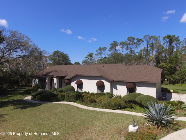 view of front of home featuring a front lawn and stucco siding