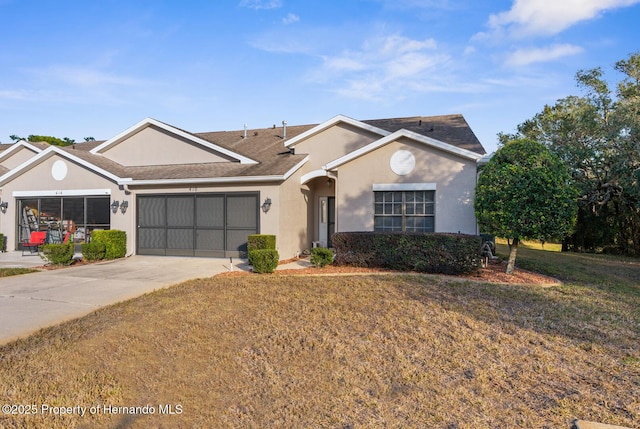 ranch-style house featuring a garage and a front lawn