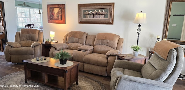 living room with crown molding and dark hardwood / wood-style flooring