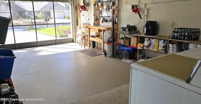 laundry room featuring washer / dryer and a workshop area