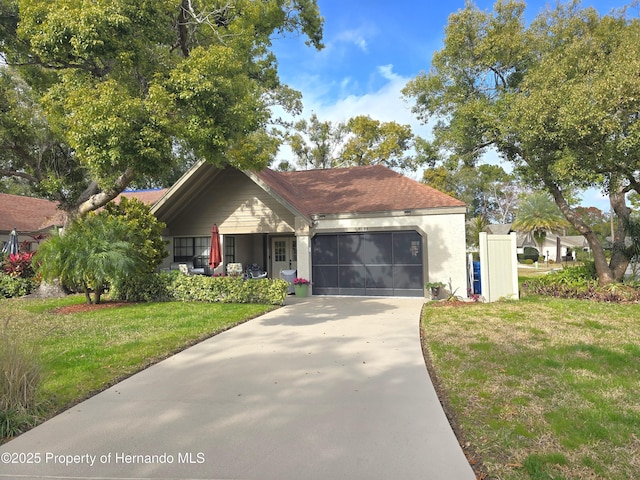 view of front of home featuring a garage and a front lawn