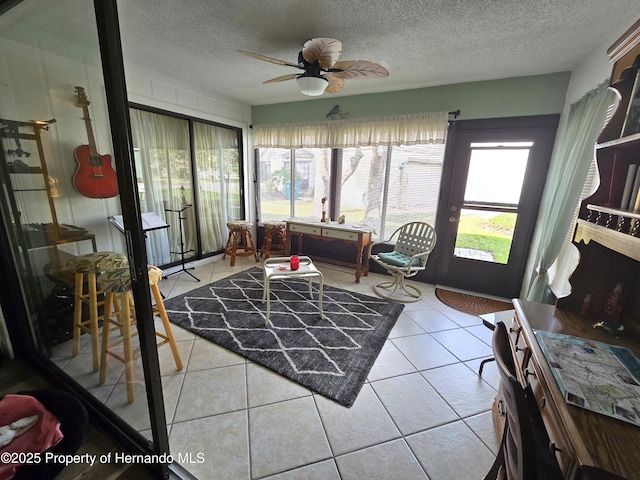 sunroom / solarium with plenty of natural light and ceiling fan