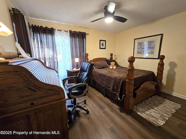 bedroom featuring ceiling fan, wood-type flooring, and a textured ceiling