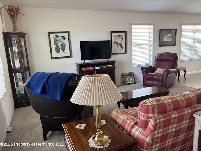 living room featuring carpet floors and baseboards