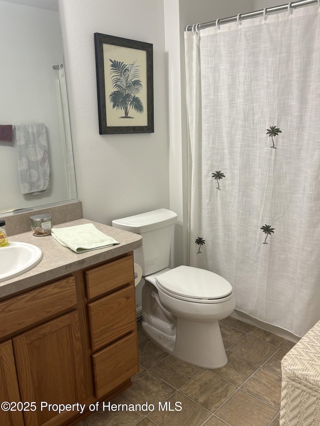 full bath featuring a shower with curtain, vanity, toilet, and tile patterned floors