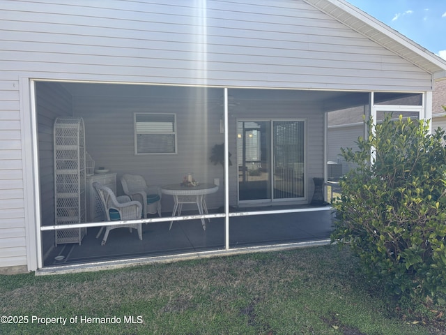 back of property with a sunroom