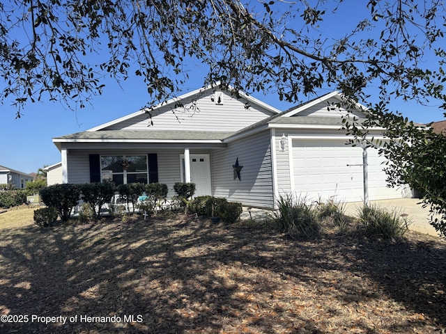 ranch-style house featuring driveway and an attached garage