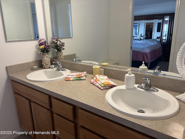 ensuite bathroom featuring connected bathroom and vanity