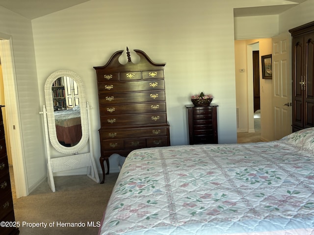 bedroom featuring carpet and vaulted ceiling