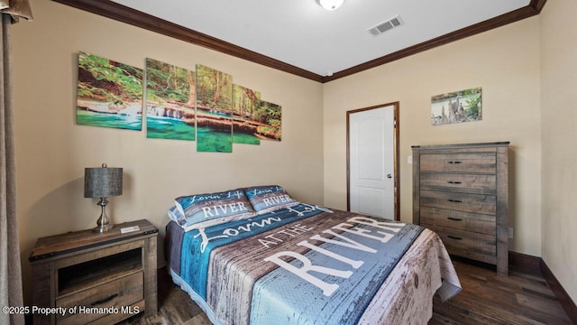 bedroom with ornamental molding and dark hardwood / wood-style floors