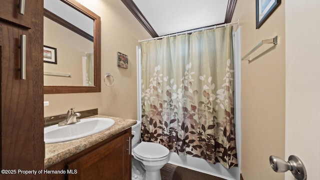 full bathroom featuring crown molding, vanity, toilet, and shower / tub combo