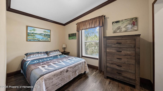 bedroom featuring ornamental molding and dark hardwood / wood-style floors