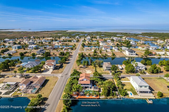 drone / aerial view with a residential view and a water view
