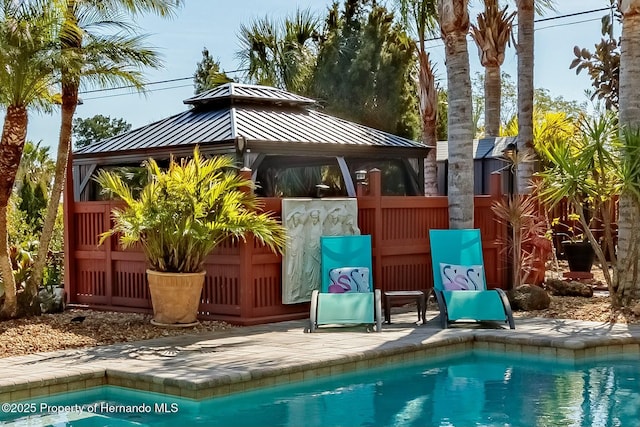 outdoor pool with a patio and a gazebo