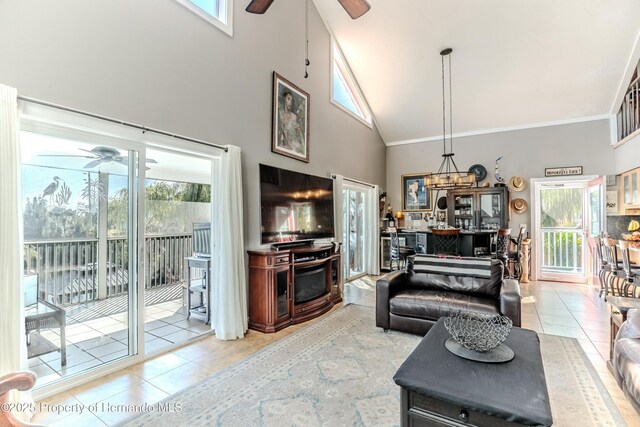 living room featuring ornamental molding, ceiling fan, tile patterned floors, and high vaulted ceiling