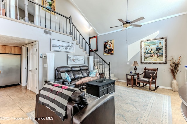 living area featuring visible vents, crown molding, stairs, high vaulted ceiling, and a ceiling fan
