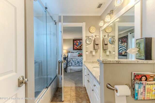 bathroom featuring crown molding, shower / bath combination with glass door, vanity, ensuite bathroom, and visible vents
