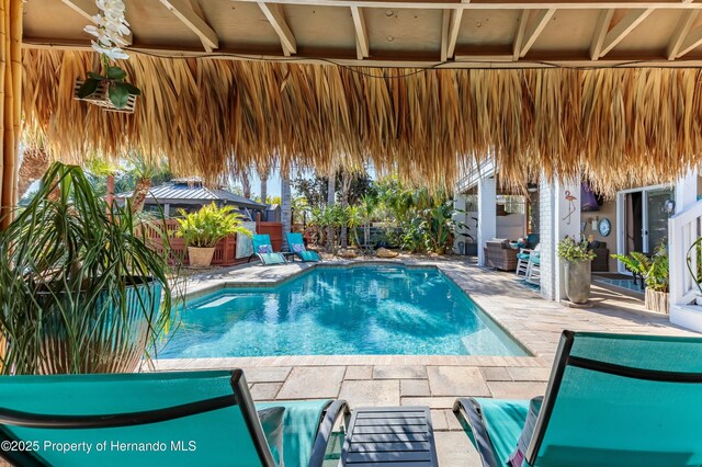 view of swimming pool featuring a fenced in pool, a fenced backyard, and a patio area