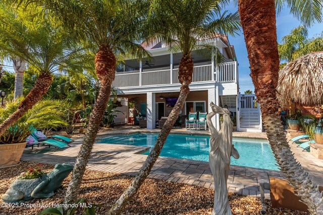 pool with stairs, a patio area, and outdoor lounge area