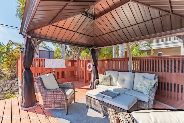 wooden terrace featuring a gazebo and outdoor lounge area