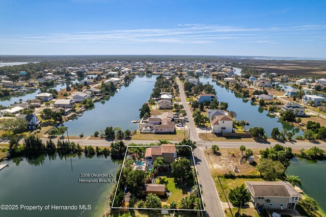 drone / aerial view featuring a water view and a residential view