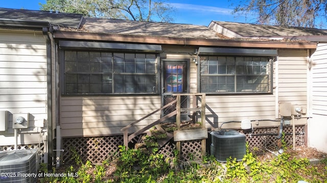 doorway to property featuring central air condition unit