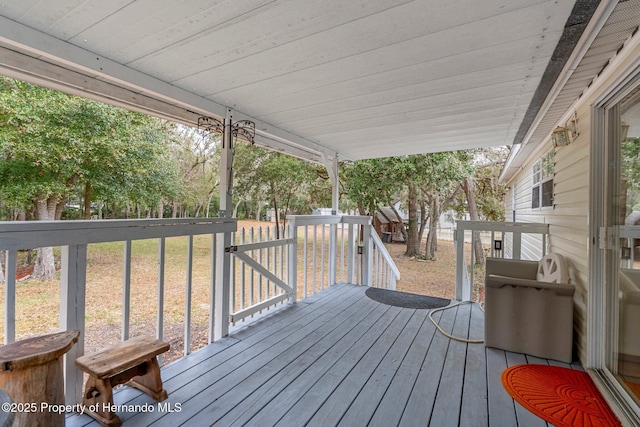 wooden deck with a lawn