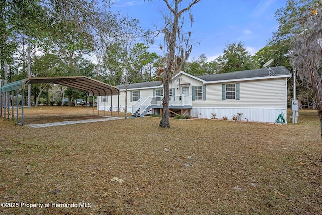 manufactured / mobile home with a carport and a front lawn