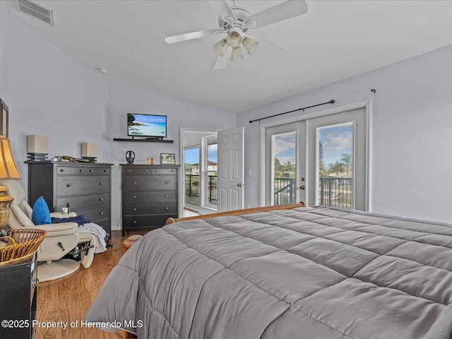 bedroom with vaulted ceiling, wood-type flooring, access to outside, ceiling fan, and french doors